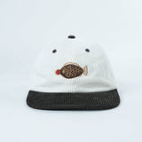 White cap with black brim and fish embroidery on a light gray background
